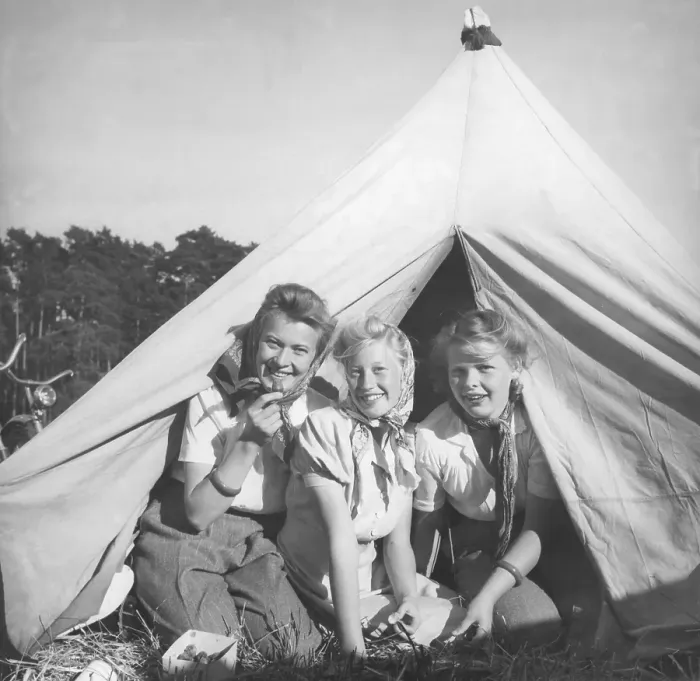 Framed Print : Camping in the 1940s. Three friends are sitting in the entrance of their tent