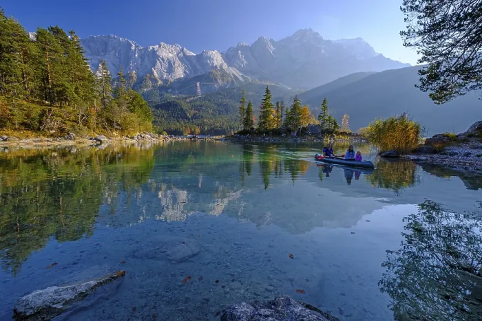Framed Print : Canoeists on a mountain lake in front of steep mountains