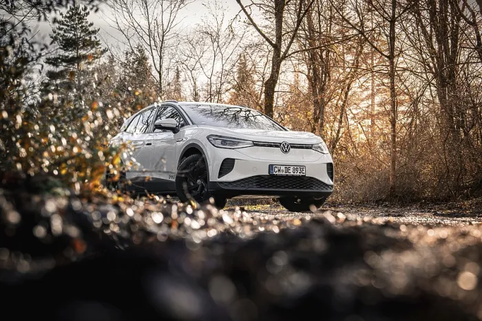 Framed Print : Car in an autumn forest landscape with bare trees