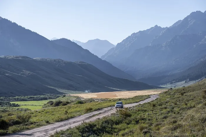 Framed Print : Car on gravel road, Tien Shan Mountains Framed Print : Car on gravel road, Tien Shan Mountains