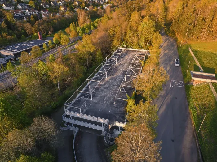 Framed Print : Empty car park surrounded by dense trees and a road in the evening light Framed Print : Empty car park surrounded by dense trees and a road in the evening light