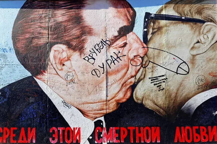 Framed Print : Caricature-like graffiti of two kissing faces with humorous style