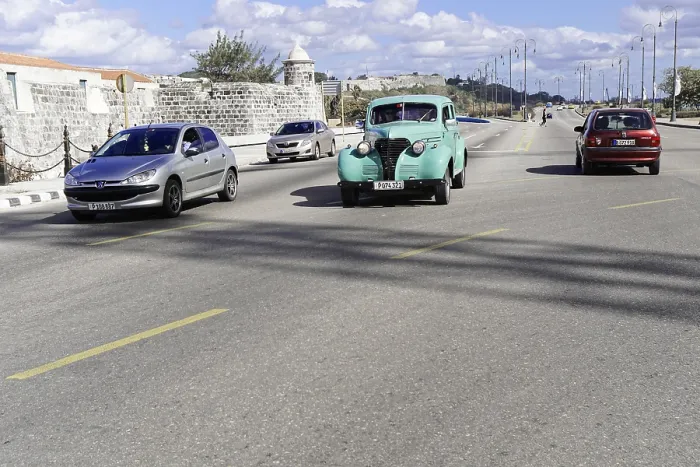 Framed Print : Several cars, including a vintage car
