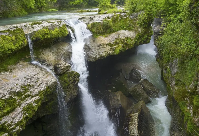 Framed Print : Cascading water through green, rocky gorge in lush nature