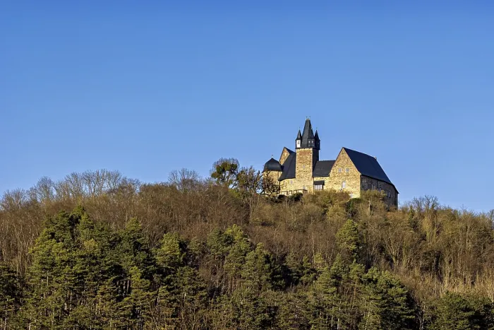 Framed Print : Castle in the distance on a wooded hill