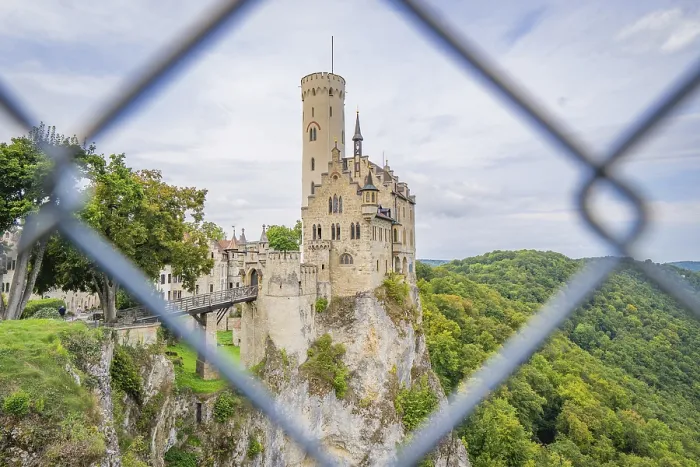 Framed Print : Castle on a hill, framed by green forest and viewed through a lattice Framed Print : Castle on a hill, framed by green forest and viewed through a lattice