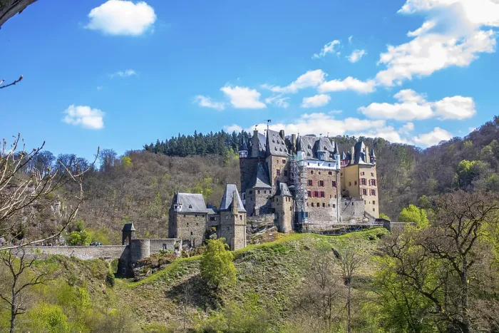 Framed Print : Castle in the valley surrounded by a green beech forest