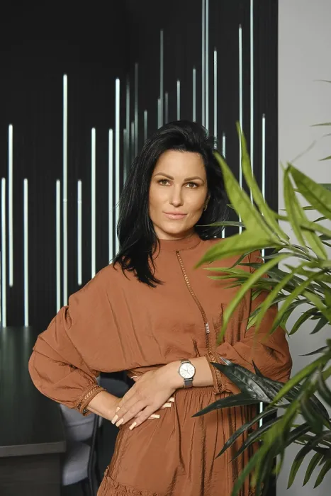 Framed Print : Casual lifestyle portrait of charming woman with black hair wearing brown dress posing near the potted plant