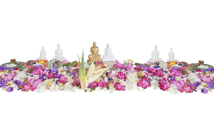 Framed Print : Ceremonial flowers and buddha figurines isolated on white background