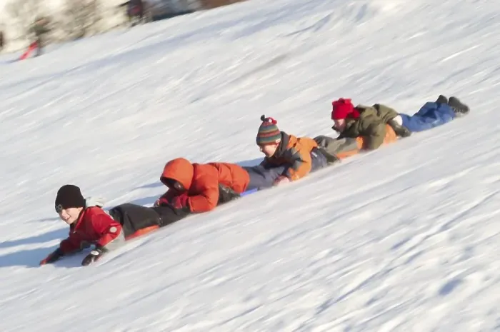 Framed Print : Chain of children sliding on their bellies downhill