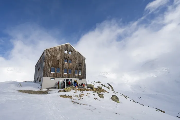 Framed Print : Chamanna Es-cha mountain hut in a cloudy winter mountain landscape