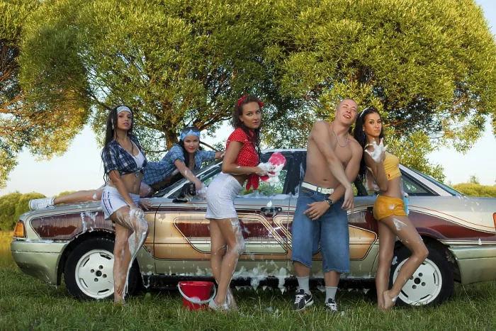 Framed Print : Cheerful female friends sitting on trunk of vintage car and looking at camera Framed Print : Cheerful female friends sitting on trunk of vintage car and looking at camera