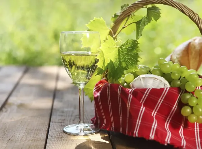 Framed Print : Cheese, grapes, bread and two glasses of the white wine outdoors