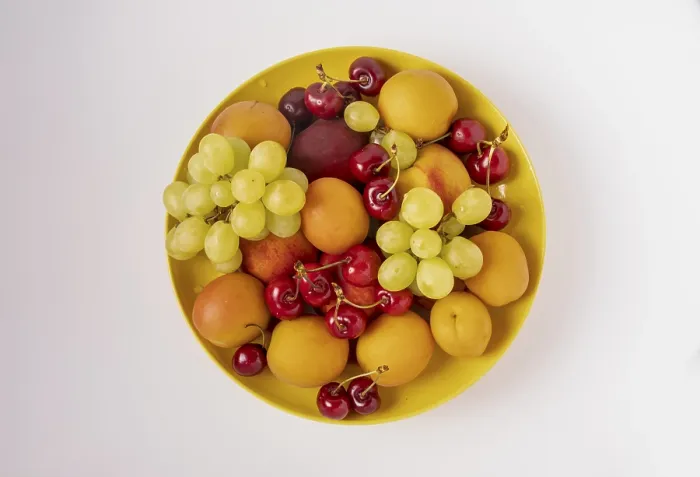 Framed Print : Cherries, apricots, green grapes of the new harvest lie on a round plate on a white background Framed Print : Cherries, apricots, green grapes of the new harvest lie on a round plate on a white background