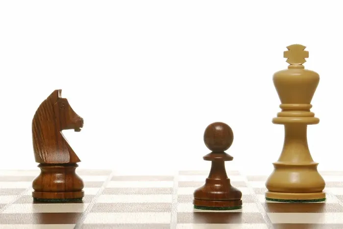 Framed Print : Chess pieces on a chess board, symbolic of strategy Framed Print : Chess pieces on a chess board, symbolic of strategy