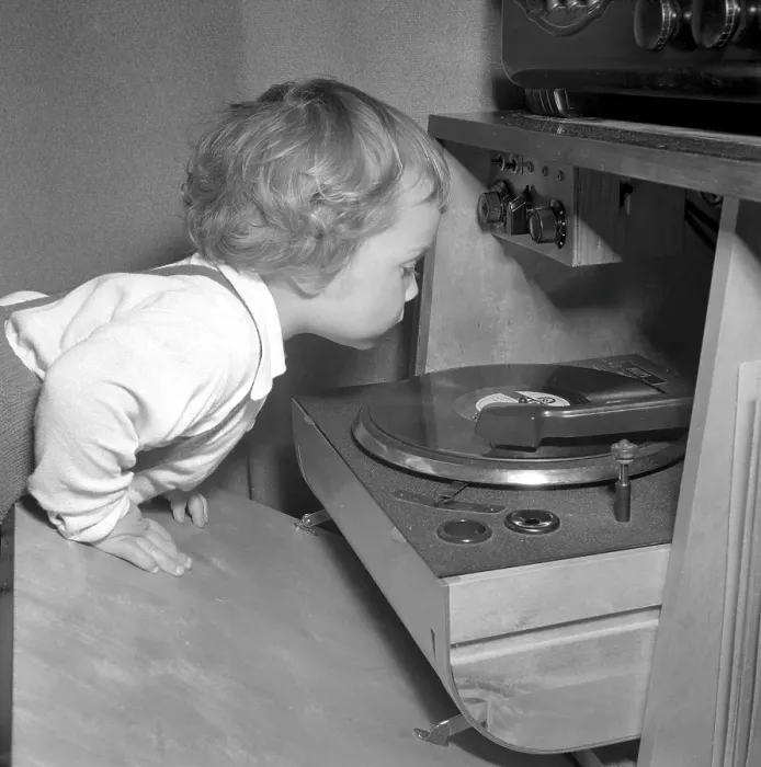 Framed Print : Child at a gramophone in the 1950s