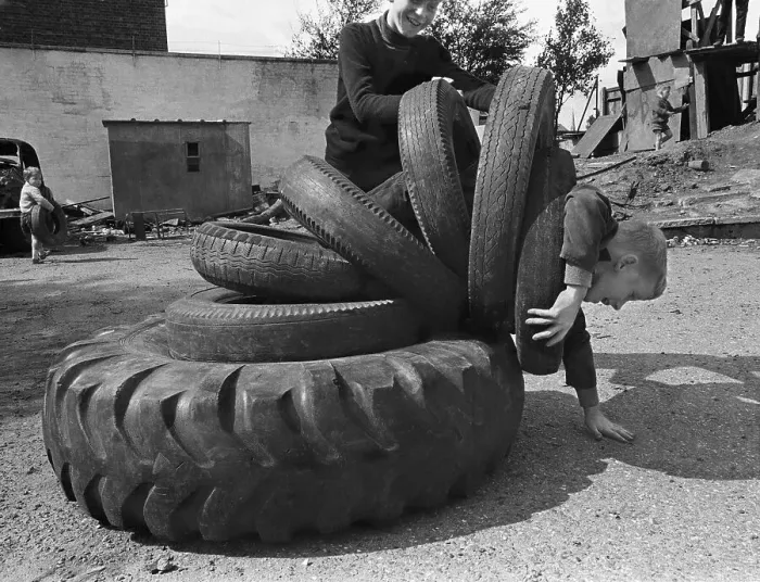 Framed Print : Child playing with tyres, England, Great Britain