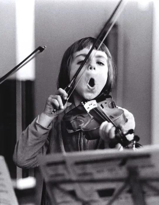 Framed Print : Child plays violin and sings, England
