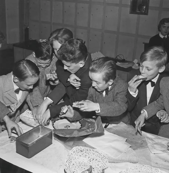 Framed Print : Children in the 1950s. A group of boys at a party are grabbing and fighting over the cookies and buns