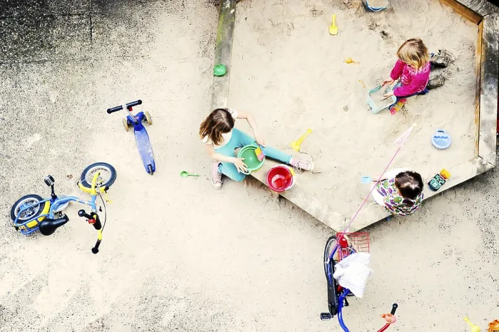 Framed Print : Children playing in the sandbox of a backyard