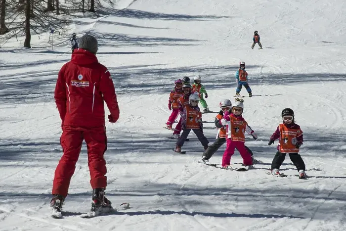 Framed Print : Children ski lessons with instructor on the piste