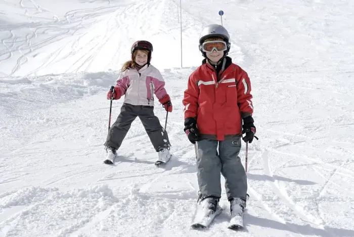 Framed Print : Two children skiing in the mountains