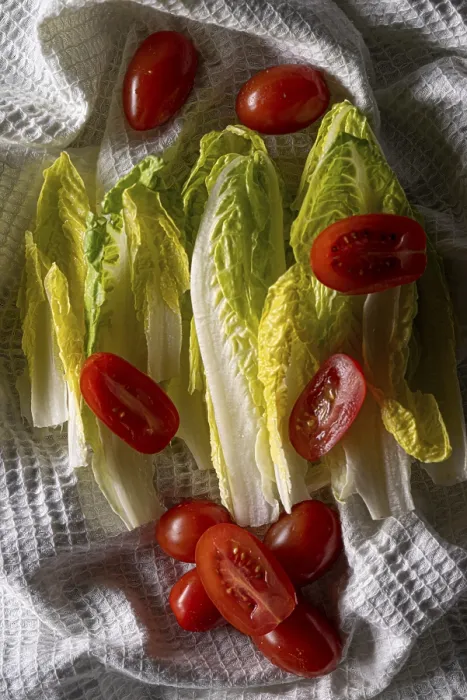 Framed Print : Chinese cabbage with cherry tomatoes on a white tea towel