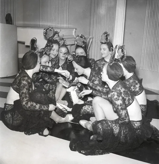 Framed Print : Chocolate in the 1940s. A group of women are eating from a box of chocolates on a film set