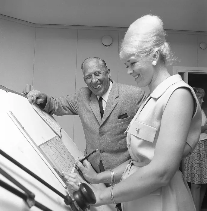 Framed Print : Chocolate in the 1960s. A woman in an office has her hair in the typical Beehive hairstyle