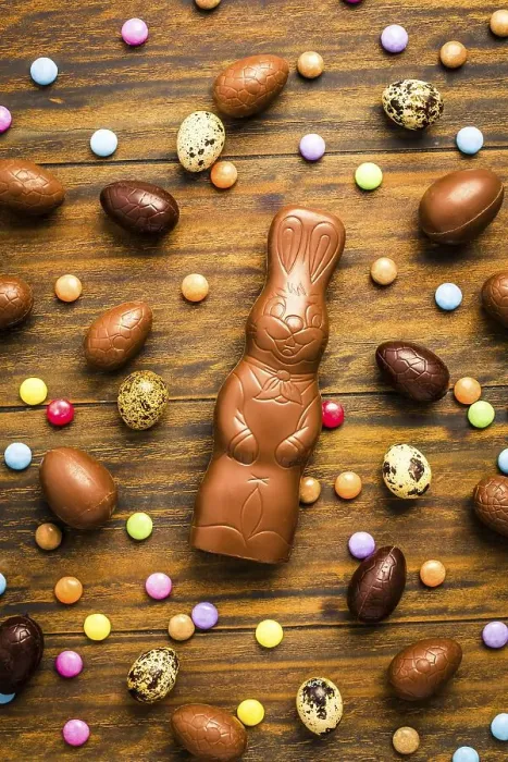 Framed Print : Chocolate Easter bunny with sweet chocolate eggs and colorful sweets on wooden background