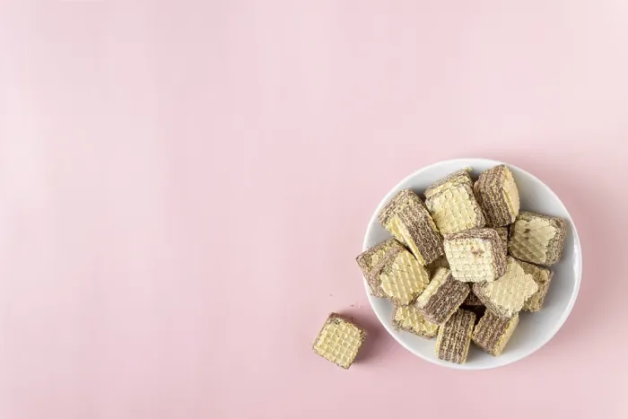 Framed Print : Chocolate mini waffles on a pink background