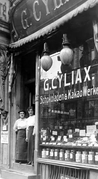 Framed Print : Chocolate shop, shop window and two shop assistants