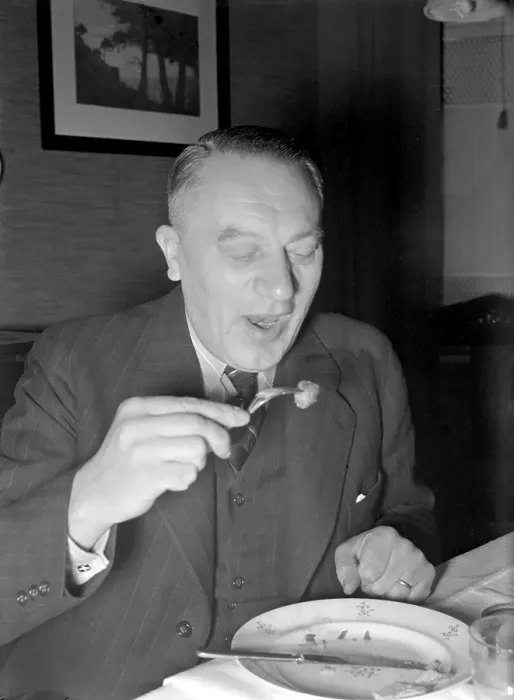 Framed Print : At christmas in the 1940s. A man is having christmas dinner and has a meatball on his fork ready to eat Framed Print : At christmas in the 1940s. A man is having christmas dinner and has a meatball on his fork ready to eat