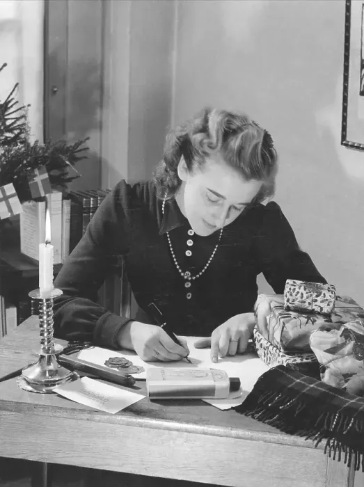 Framed Print : Christmas in the 1940s. A woman is wrapping christmas gifts Framed Print : Christmas in the 1940s. A woman is wrapping christmas gifts