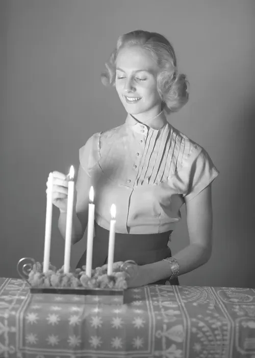 Framed Print : Christmas in the 1950s. Margit Sjoedin is lighting the candles at christmas