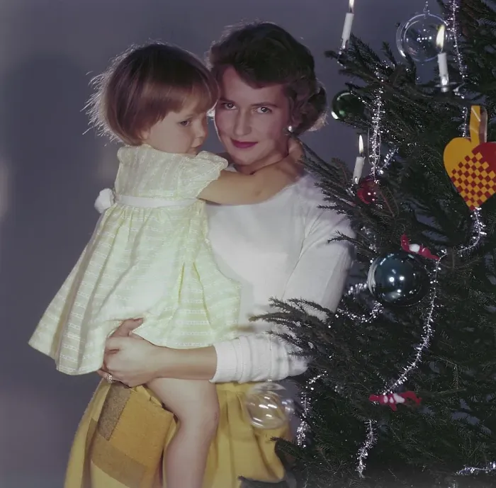 Framed Print : Christmas in the 1950s. A mother and her daughter is standing by the christmas tree