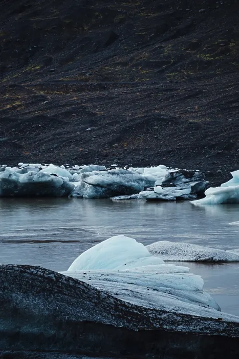 Framed Print : Chunks of blue ice floating in water with dark Framed Print : Chunks of blue ice floating in water with dark