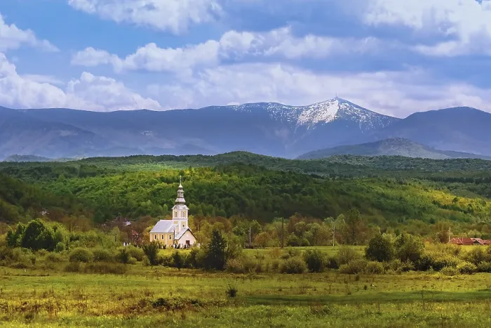 Framed Print : Church against the backdrop of the Carpathian Mountains in Romania