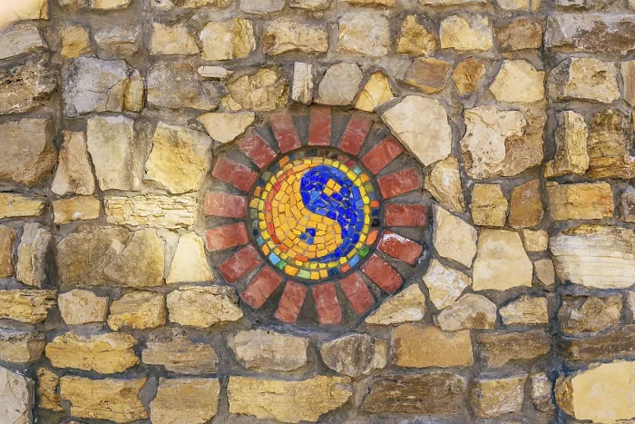 Framed Print : Circular mosaic religious symbol of Yin and yang on stone wall Framed Print : Circular mosaic religious symbol of Yin and yang on stone wall