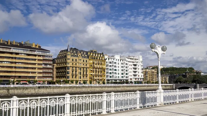 Framed Print : City landscape with classic building facades along a river and blue sky with clouds