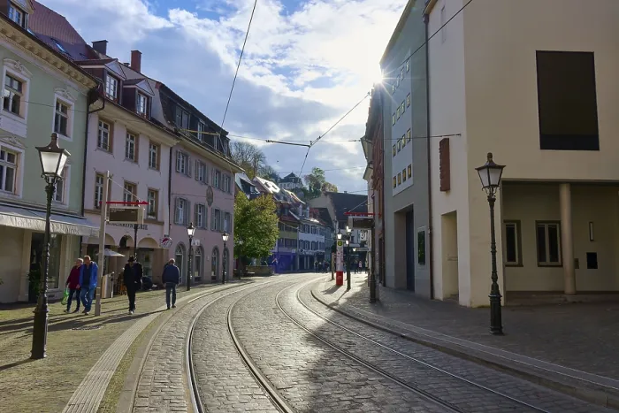 Framed Print : City street with railway tracks