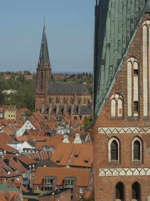Framed Print : City view with church tower and house roofs in a calm spring morning under clear blue sky