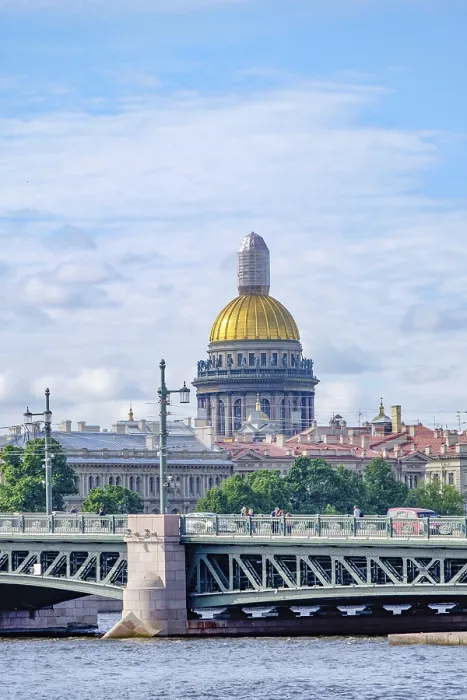 Framed Print : City view with golden dome and bridge over water under blue sky