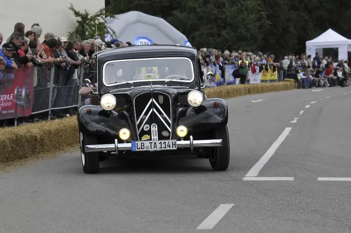 Framed Print : A classic black Citroen drives in front of spectators at a classic car race