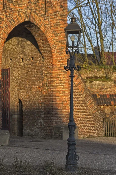 Framed Print : Classic lantern in front of historic brick building (Linn Castle gate) in the light show