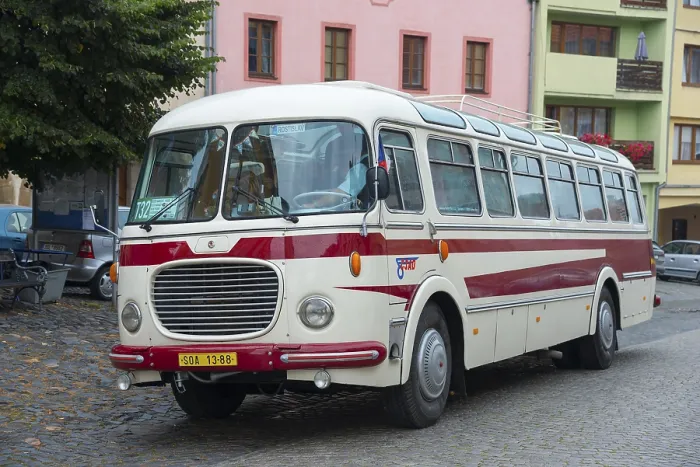 Framed Print : A classic old bus on a cobbled street in a town with colourful buildings Framed Print : A classic old bus on a cobbled street in a town with colourful buildings