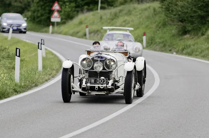 Framed Print : A classic white vintage racing car on a winding country road