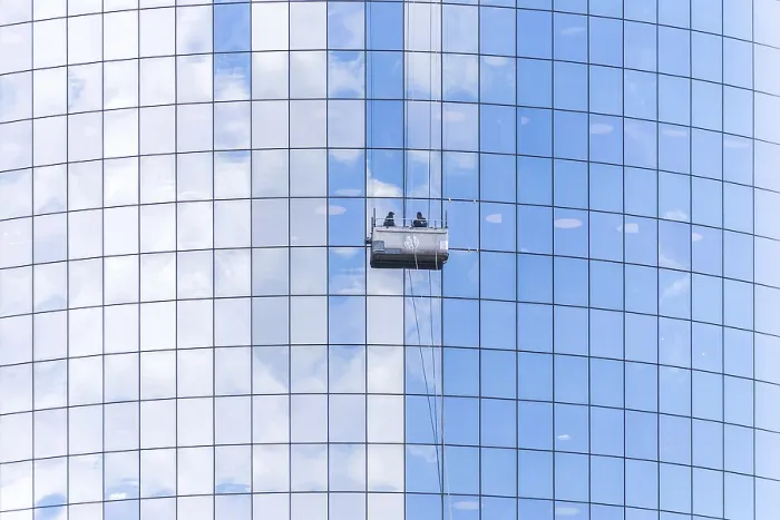 Framed Print : Two cleaners washing the windows of modern skyscraper in New York
