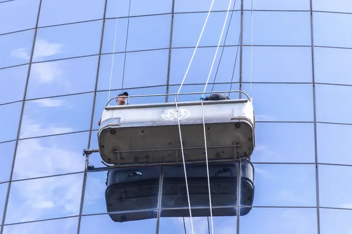 Framed Print : Two cleaners washing the windows of modern skyscraper in New York