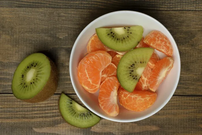 Framed Print : Clementine pieces and kiwi slices in peel